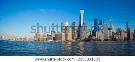 New York City's Lower Manhattan skylines and Brooklyn bridge with the famous One World Trade Center building during a day
