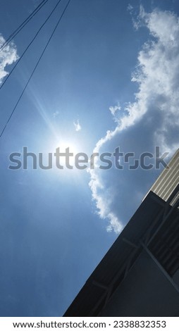 Blue sky with sun and clouds