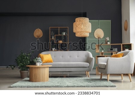 Interior of modern living room with grey sofa, armchair and wooden coffee table Royalty-Free Stock Photo #2338834701