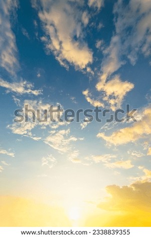 vertical Sky blue and orange light of the sun through the clouds in the sky Royalty-Free Stock Photo #2338839355