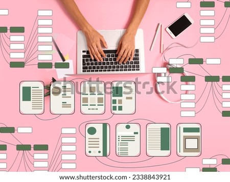 Hands with laptop and different website wireframes on pink background
