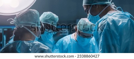Team of medical doctors performs surgical operation in modern operating room using high-tech technology. Surgeons are working to save the patient in the hospital. Medicine, health and science. Royalty-Free Stock Photo #2338860427
