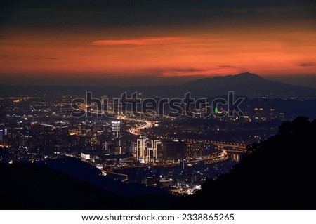 Heavy traffic in the city, time-lapse photography of car lights. View of the urban landscape from Dajianshan Mountain, New Taipei City.