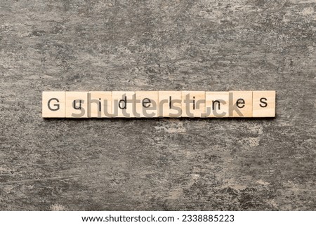 Guidelines word written on wood block. Guidelines text on table, concept. Royalty-Free Stock Photo #2338885223