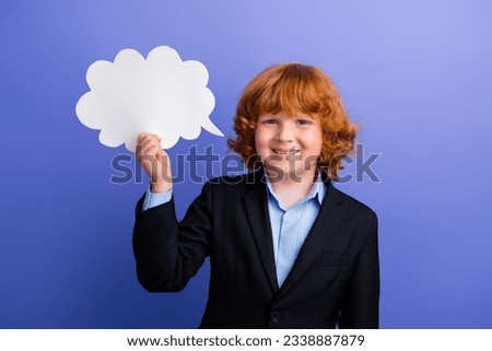 Photo of cheerful person toothy smile hand hold empty space cloud shape bubble card isolated on violet color background