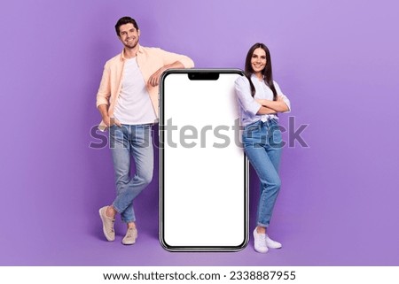 Full length portrait of two attractive people crossed hands demonstrate big empty space smart phone isolated on purple color background