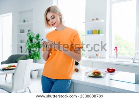 Photo of focused lady housewife girfriend search web device perfect dinner for family in modern kitchen interior