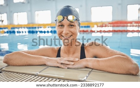 Portrait, woman in water and swimming pool for competition, training or professional sports or exercise in gym or club. Swimmer, athlete and smile of happiness for wellness, fitness or cardio workout