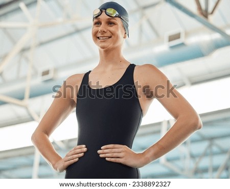 Sports, smile and goggles with a woman swimmer getting ready for an event, race or competition in a gym. Fitness, exercise and workout with a happy young female athlete training at a swimming pool