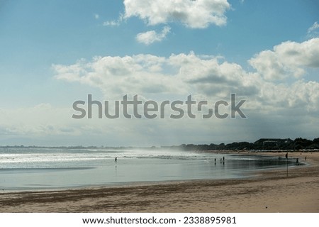 a sunny day at the beach with clouds in the sky