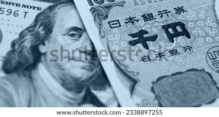 Japanese Yen and US dollar bank note, currency exchange rate Royalty-Free Stock Photo #2338897255
