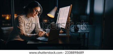 Caucasian woman works late from her home office, typing her ideas on her laptop. Professional business woman working late hours, maintaining a work-life balance and excelling in digital marketing. Royalty-Free Stock Photo #2338898689