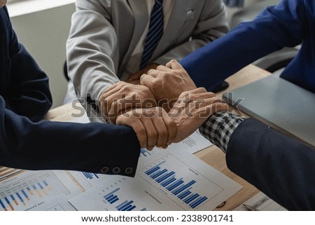 A group of business people join hands to successfully make contact, work as a team to achieve goals, hand-to-hand coordination is a symbol of unity within the organization to strive for success.