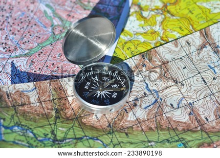 Map and compass. The magnetic compass is located on the topographic map.