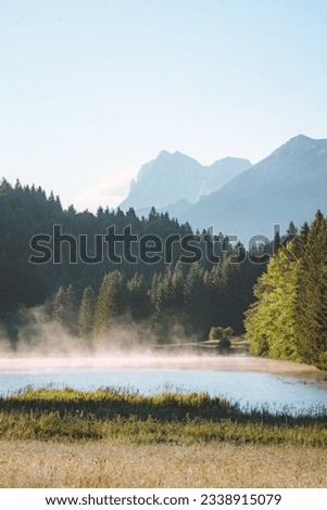 Amazing foggy Sunrise at Geroldsee, also Wagenbruchsee, Bavaria, Germany Europe Royalty-Free Stock Photo #2338915079