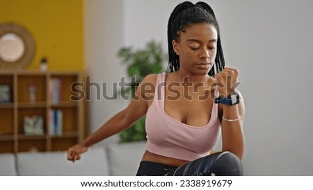 African american woman wearing sportswear training at home