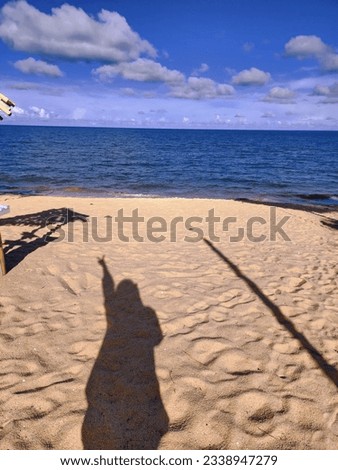 Stand  infront the beach and taking a beatiful shadow picture.