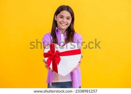 teen girl hold gift on Valentines Day. teen girl holding box of chocolates. be my valentine. teen girl hold heart box for Valentines Day. teen girl has Valentines mood. for the sweetheart