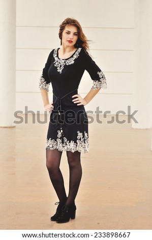teen girl wearing dress is posing