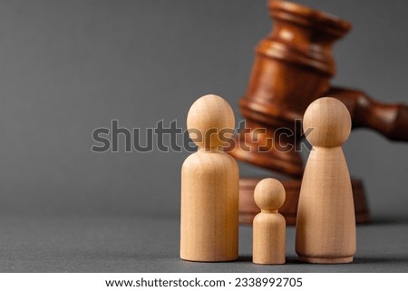 Wooden toy family and judge mallet. Family divorce concept Royalty-Free Stock Photo #2338992705