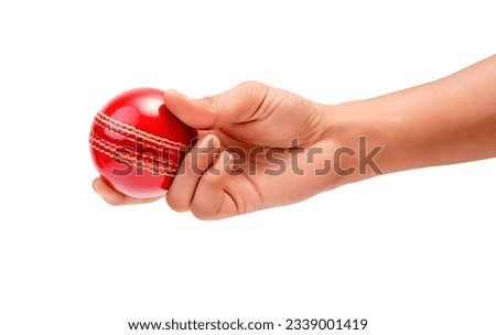 A Male Hand Holding A Red Test Match Leather Stitch Cricket Ball Closeup Picture White Background