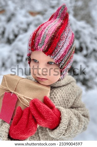 Toddler holding a surprise in winter