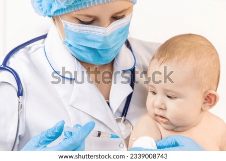 Vaccination of a baby by a doctor in a hospital. Selective focus. medicine. Royalty-Free Stock Photo #2339008743