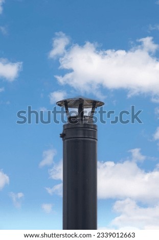 A Steel Chimney Stack With Clouds