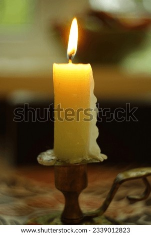 Burning candle on a blurred backgroundю.
