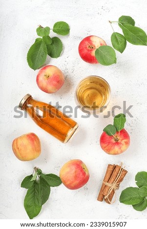 Apple cider, juice or fruit drink and ingredients on a sunny table. The concept of diet and weight loss. Apples help cleanse the body and reduce weight. Healthy food, body detoxification, 