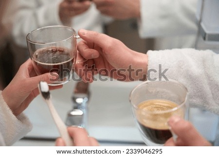 Close-up of male and female hand holding cup of coffee