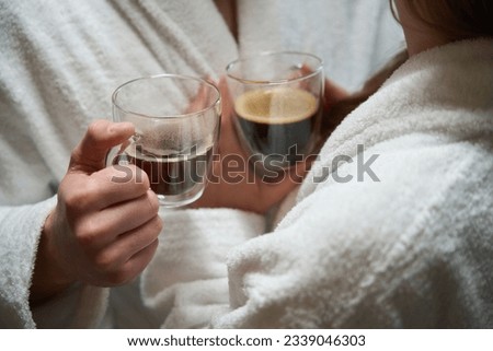 Close-up of woman hand passing cup of coffee to man