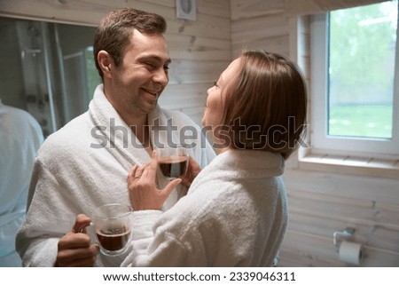 Young man and woman in the bathroom looking at each other