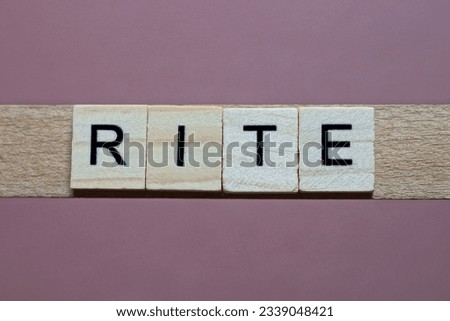 gray word rite made of wooden square letters on brown background