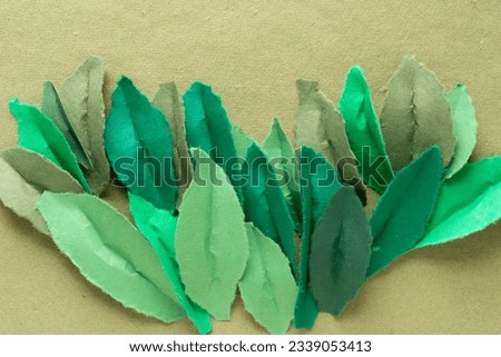 decorative torn paper leaves with oval or almond form layered or overlapping on rough green scrapbook paper Royalty-Free Stock Photo #2339053413