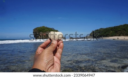 A Picture of love stone on the hand with the beach background