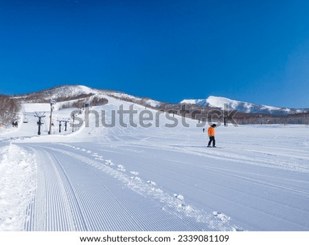 Freshly pressed piste in a quiet ski resort at early morning on a clear day (Niseko Moiwa, Hokkaido, Japan) Royalty-Free Stock Photo #2339081109