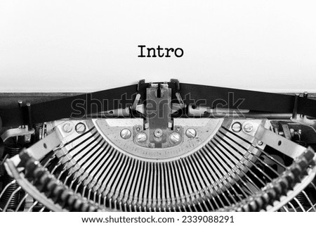 Intro word close up being typing and centered on a sheet of paper on old vintage typewriter mechanical Royalty-Free Stock Photo #2339088291