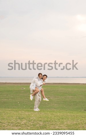 Happy young Asian couple in bride and groom clothing ready for marry and wedding celebrate