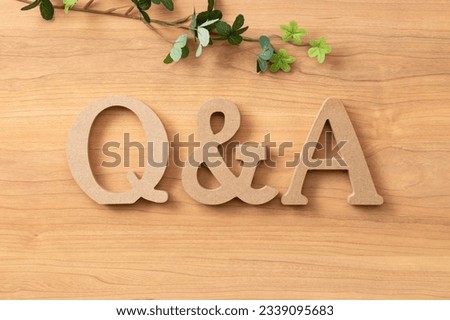 Q and A objects on wood background.