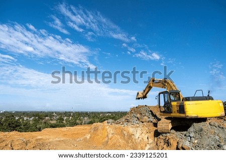 photo of the view from the top of the hill with an excavator machine at work
