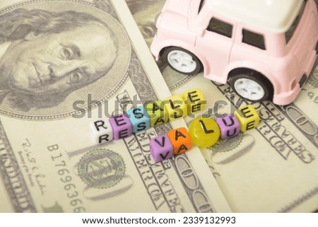 Photos featuring toy cars with miniature dollar bills, symbolizing the potential profits in the car resale value market Royalty-Free Stock Photo #2339132993