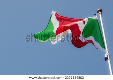 Burundi flag in the blue sky. horizontal panoramic banner. Close-up of waving the flag of Burundi. Great photo for news illustrations.