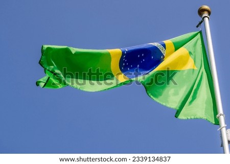 Brazil flag in the blue sky. horizontal panoramic banner. Close-up of waving the flag of Brazil. Great photo for news illustrations.