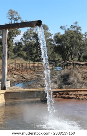 42 degree water spurting out from a bore that is tapping the great artesian basin near Cunnamulla, Queensland, Australia Royalty-Free Stock Photo #2339139159