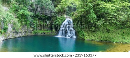 Panoramic scenery of cool Senjyudaki waterfalls surrounded by greenery seen at Akame48 Waterfalls