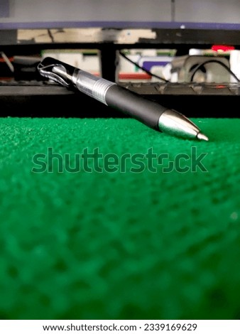 ballpoint pen image with desk and computer keyboard background