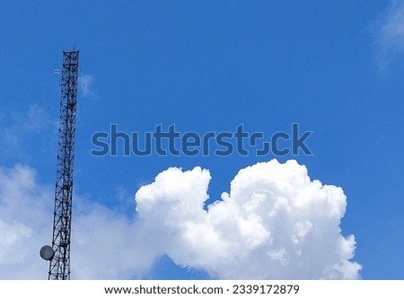 picture of tall signal tower  and sky background with clouds in summer.