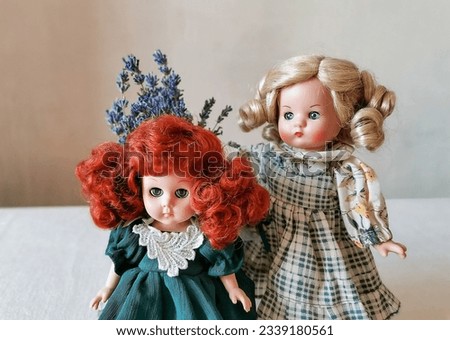Vintage dolls and lavender bouquet. Blonde and redhead. Kids toys