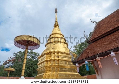 Wat Phrathat Chom Thong, is Buddhist Temple located on the mountain named Chom Thong, Phayao, Th which is the Lanna-styled chedi with its height of 30 metres is situated on the three-layer square base Royalty-Free Stock Photo #2339193931